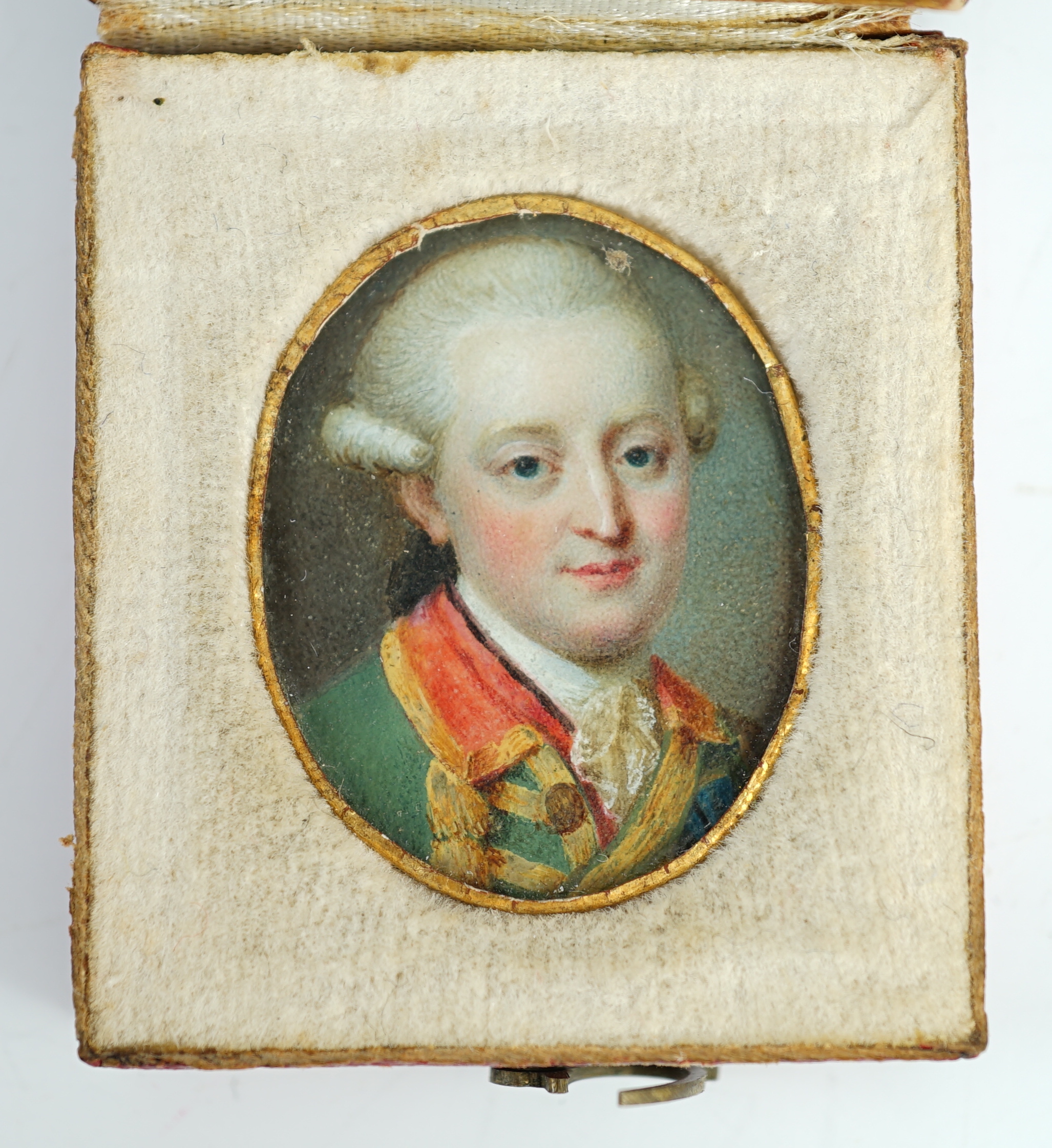 French School circa 1780, Portrait miniature of a gentleman wearing a gold brocaded green jacket, watercolour on ivory, 2.5 x 2cm, red leather case. CITES Submission reference GHZLAP5D